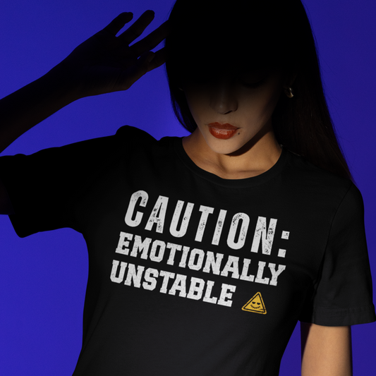 Person wearing a black t-shirt with 'CAUTION: EMOTIONALLY UNSTABLE' text on a blue background