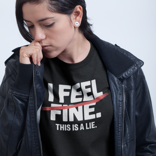 Person wearing a black t-shirt with text 'I FEEL FINE. THIS IS A LIE.' against a plain background