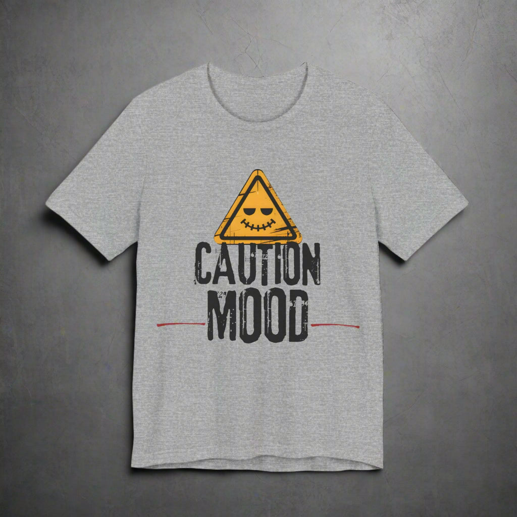 Gray t-shirt with a yellow warning triangle and 'Caution Mood' text on a grunge background