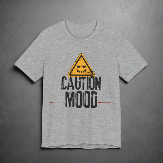 Gray t-shirt with a yellow warning triangle and 'Caution Mood' text on a grunge background