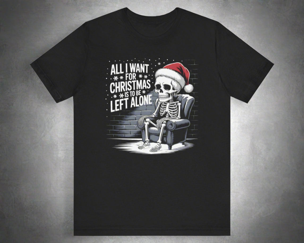 Black t-shirt with a skeleton wearing a Santa hat and text 'All I want for Christmas is to be left alone' on a white background.