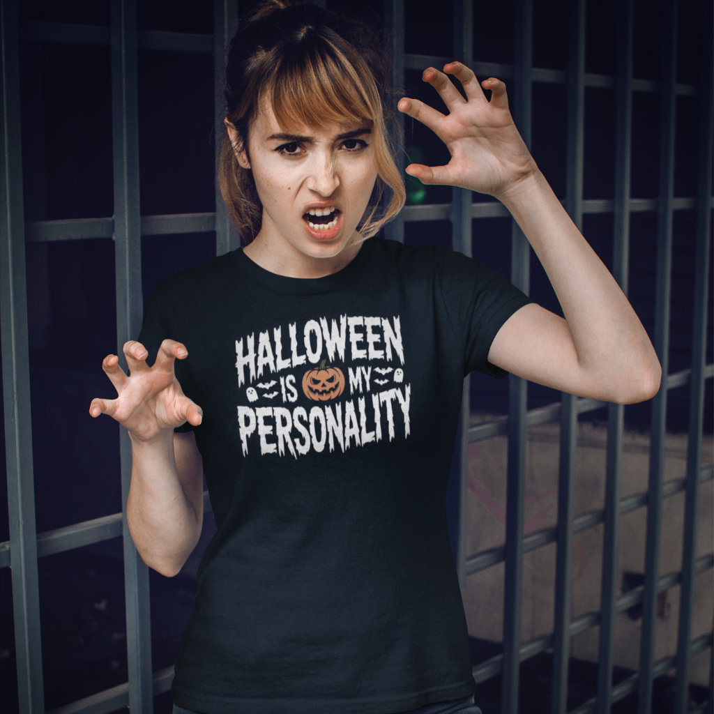 Person wearing a black t-shirt with 'Halloween is my personality' text, standing in front of a dark background.