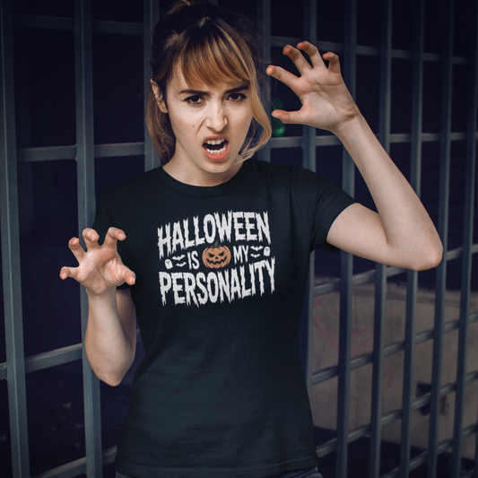 Person wearing a black t-shirt with 'Halloween is my personality' text, standing in front of a dark background.